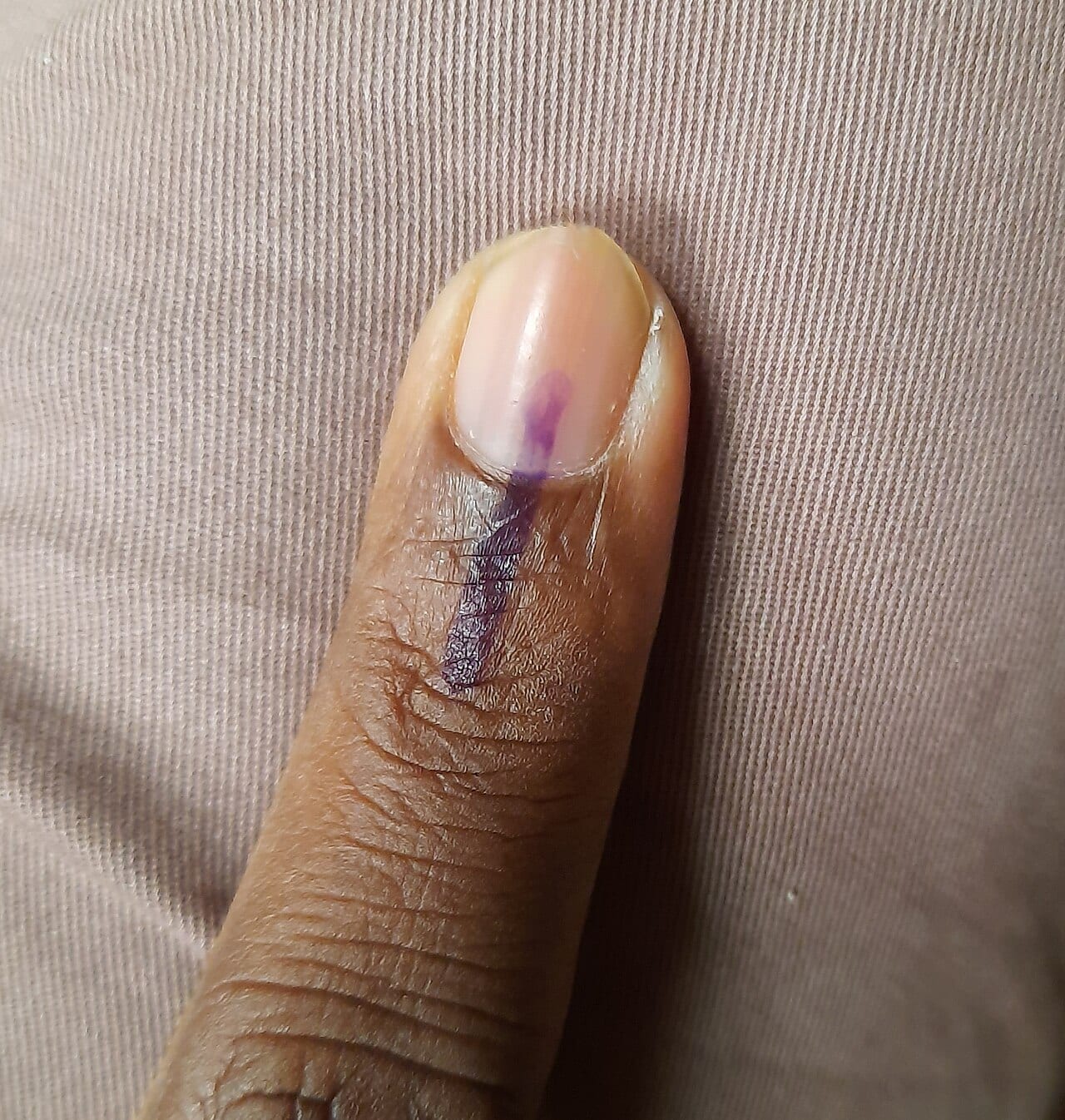 Indelible ink on a voter's index finger after voting
